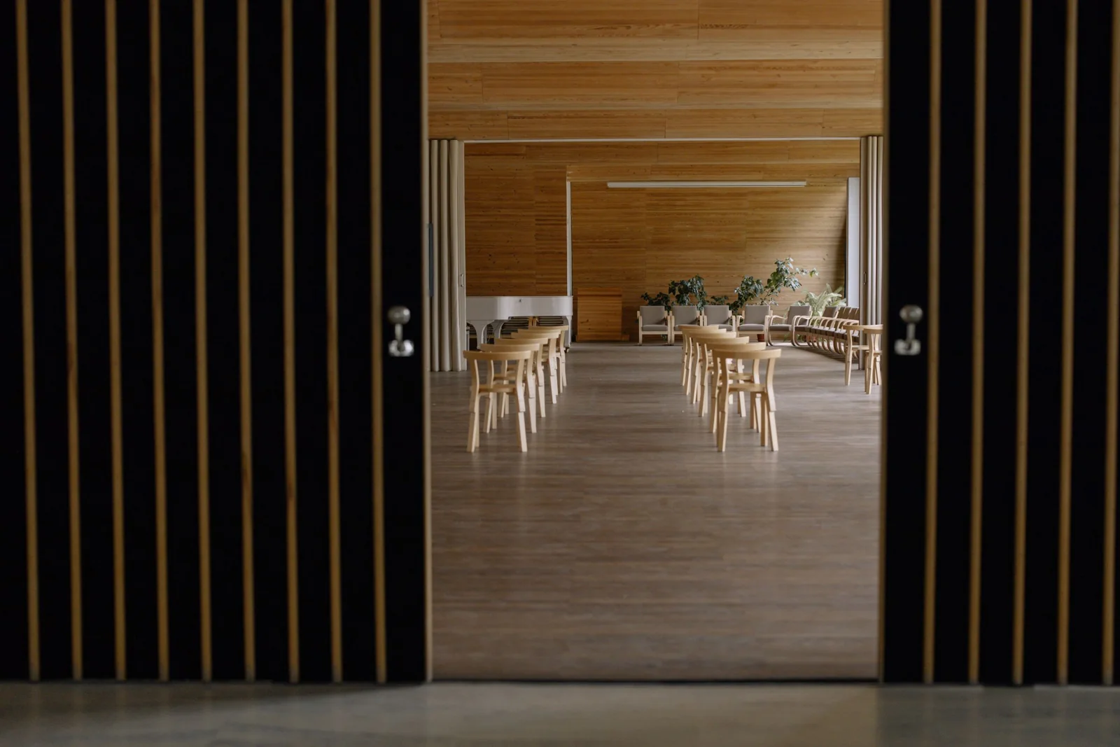 A community gathering room with chairs and a piano